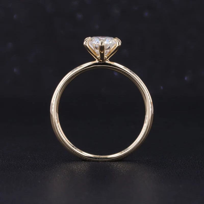 Gold ring with a diamond on a dark background