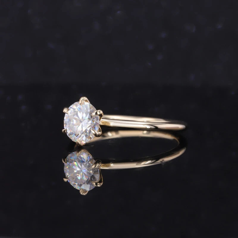 Gold ring with a diamond on a black background
