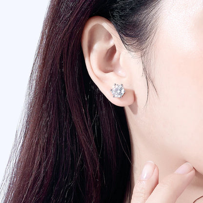 Close-up of an ear wearing a diamond earring with a blurred background