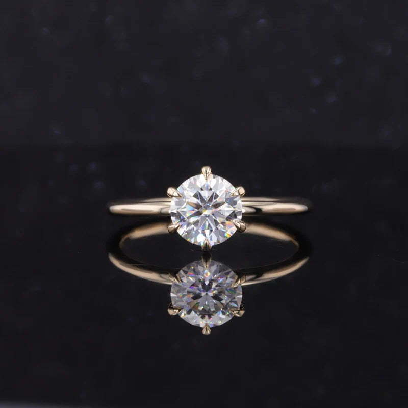 Gold ring with two diamond stones on a black background