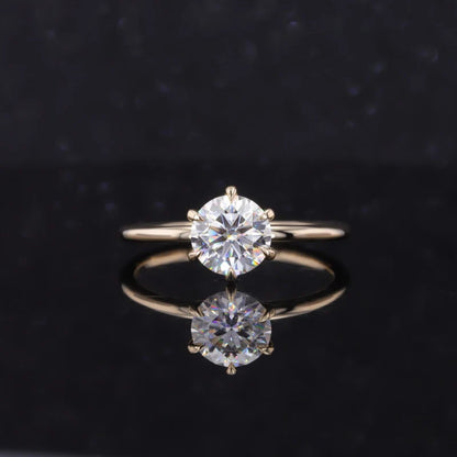 Gold ring with two diamond stones on a black background