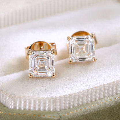 Pair of diamond stud earrings on a white surface