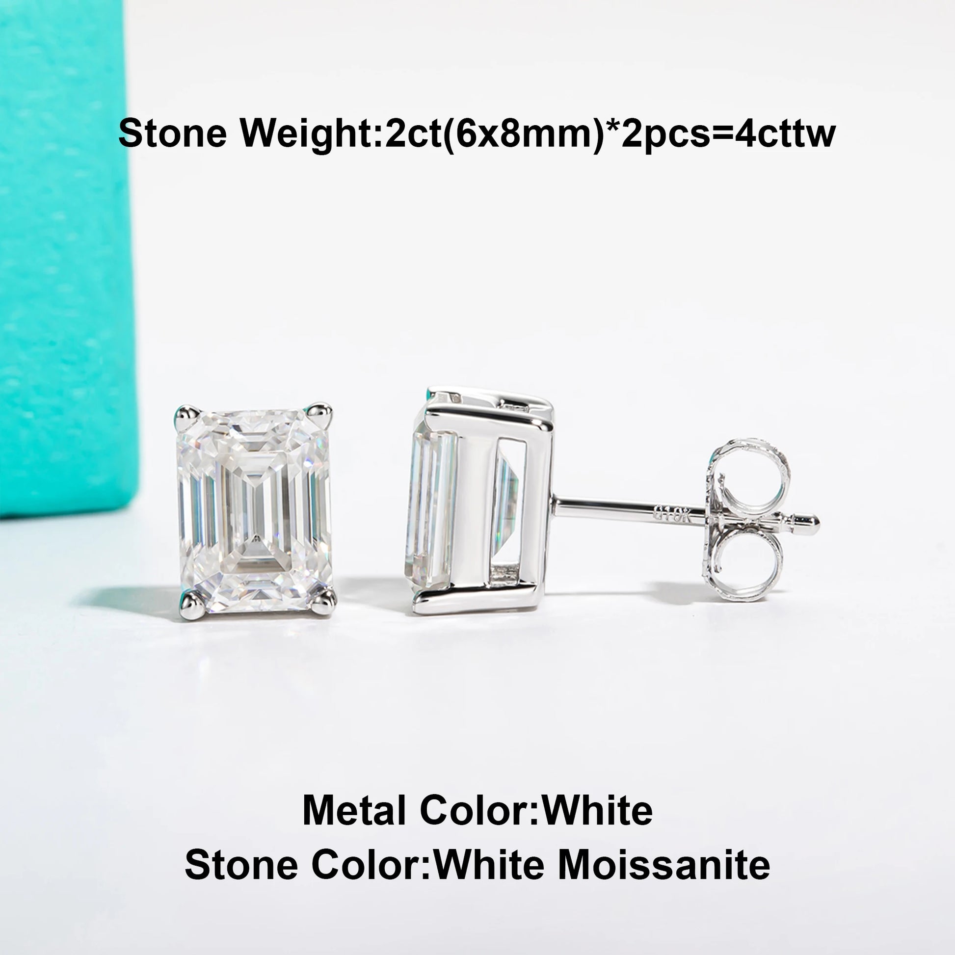 Silver earrings with emerald-cut gemstones on a white background