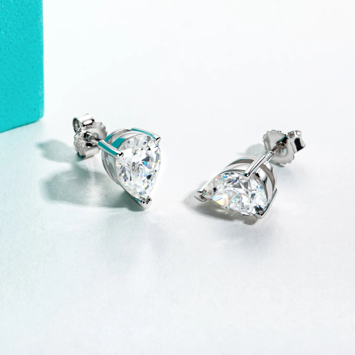 Pair of diamond stud earrings on a light background