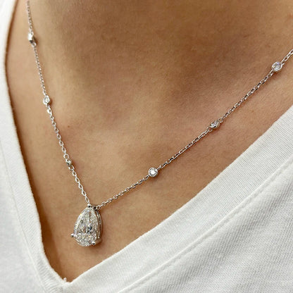 Diamond necklace on a person wearing a white top