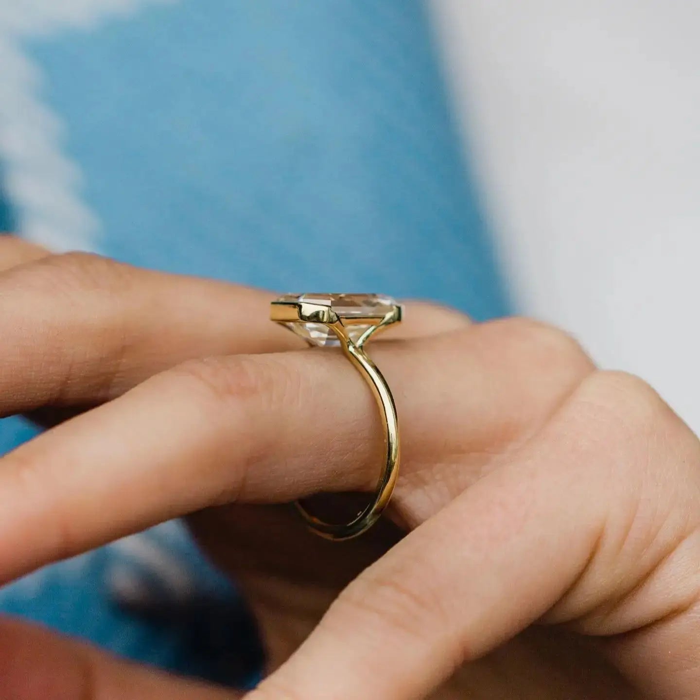 Gold ring on a finger with a blurred background