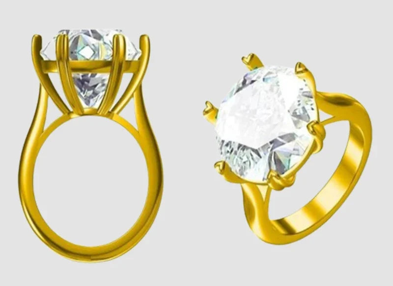 Two gold rings with large clear gemstones on a light gray background