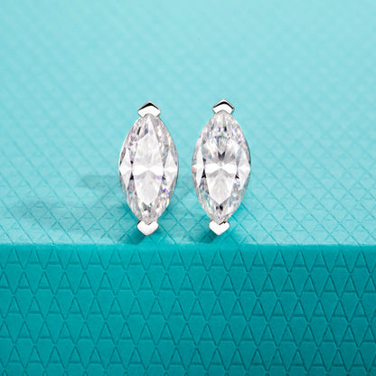 Marquise-shaped crystal earrings on a teal textured background
