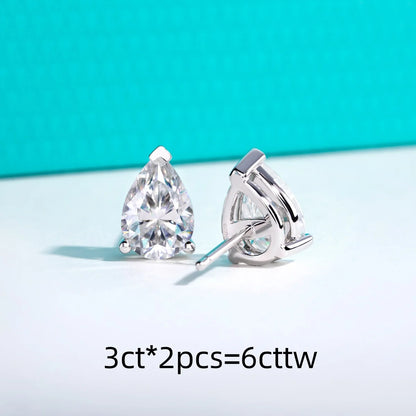 Pair of pear-shaped diamond earrings on a light blue background