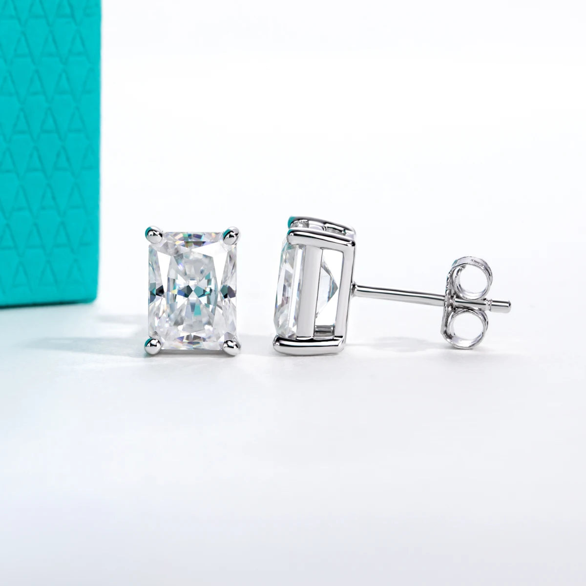 Pair of silver stud earrings with clear gemstones on a white background