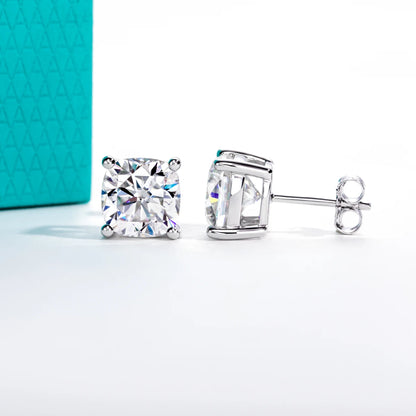 Pair of silver stud earrings with clear gemstones on a light gray background
