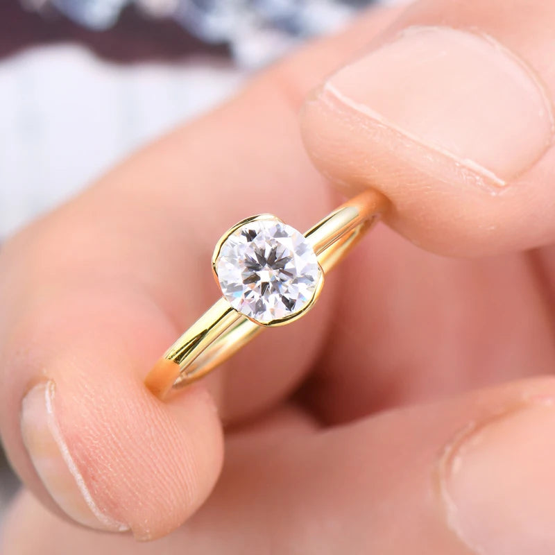 Gold ring with a diamond on a finger