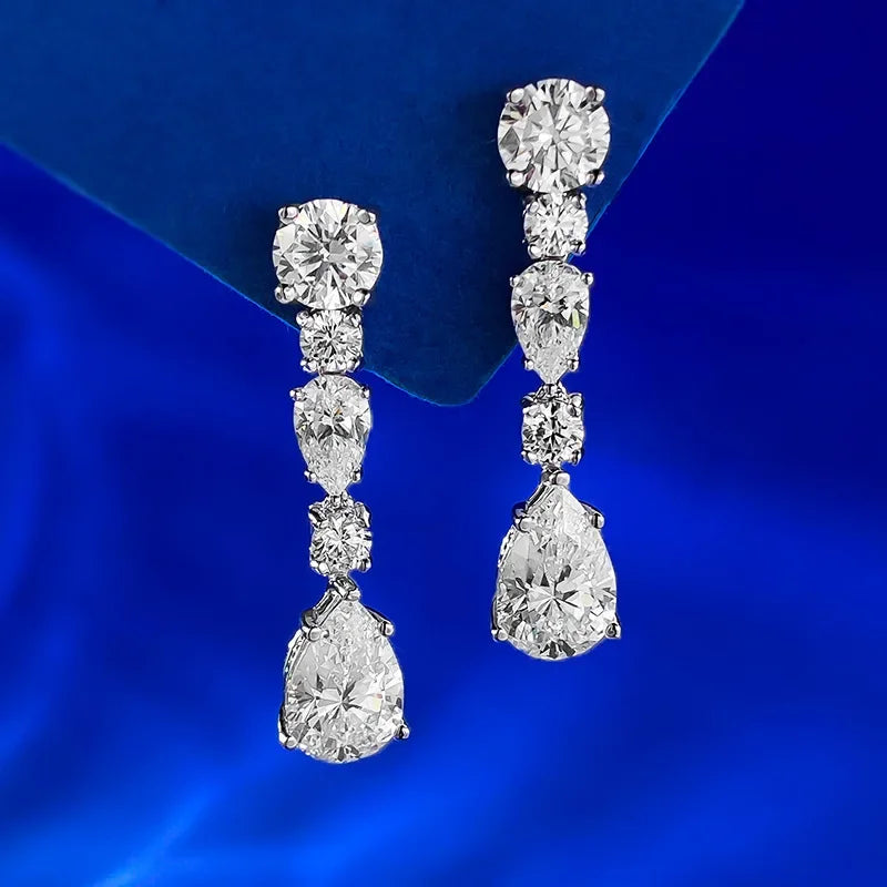 Diamond earrings on a blue fabric background