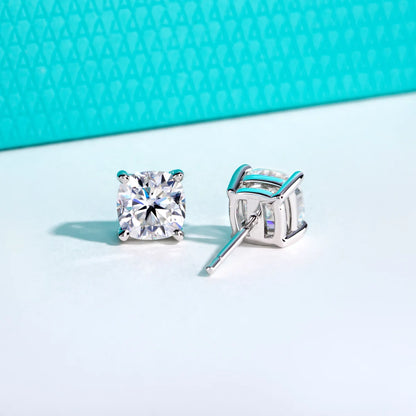 Square-cut stud earrings on a light blue background