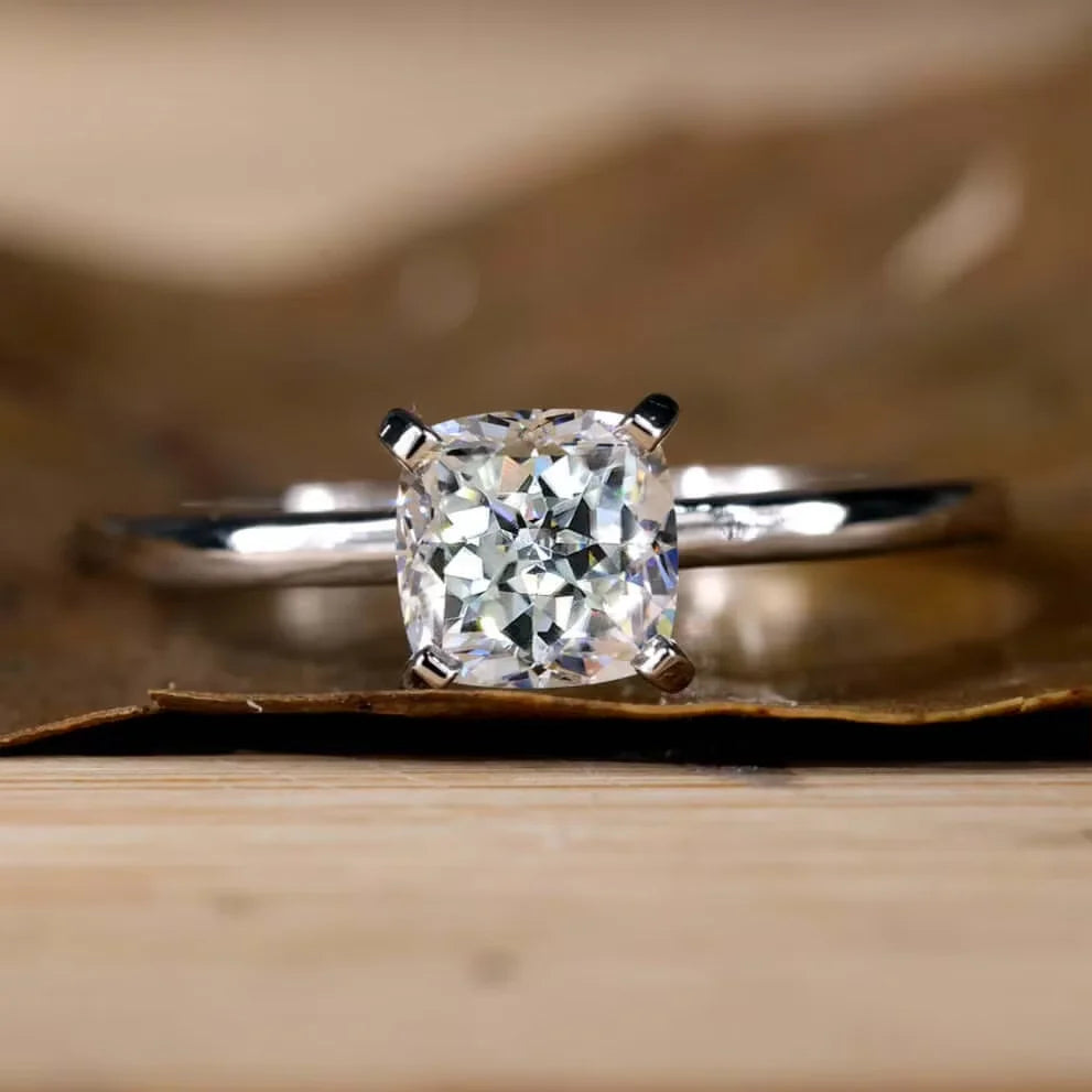 Diamond ring on a wooden surface with a blurred background