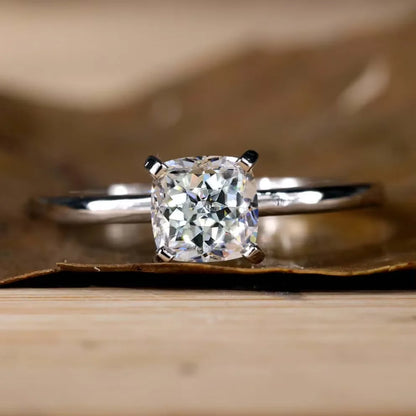 Diamond ring on a wooden surface with a blurred background