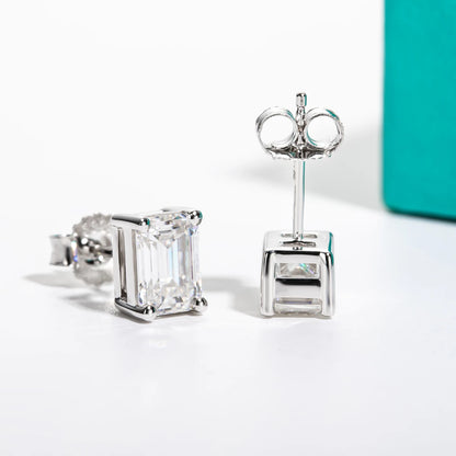 Pair of diamond stud earrings on a light background
