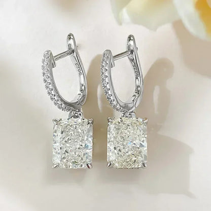 Pair of diamond earrings on a soft white background