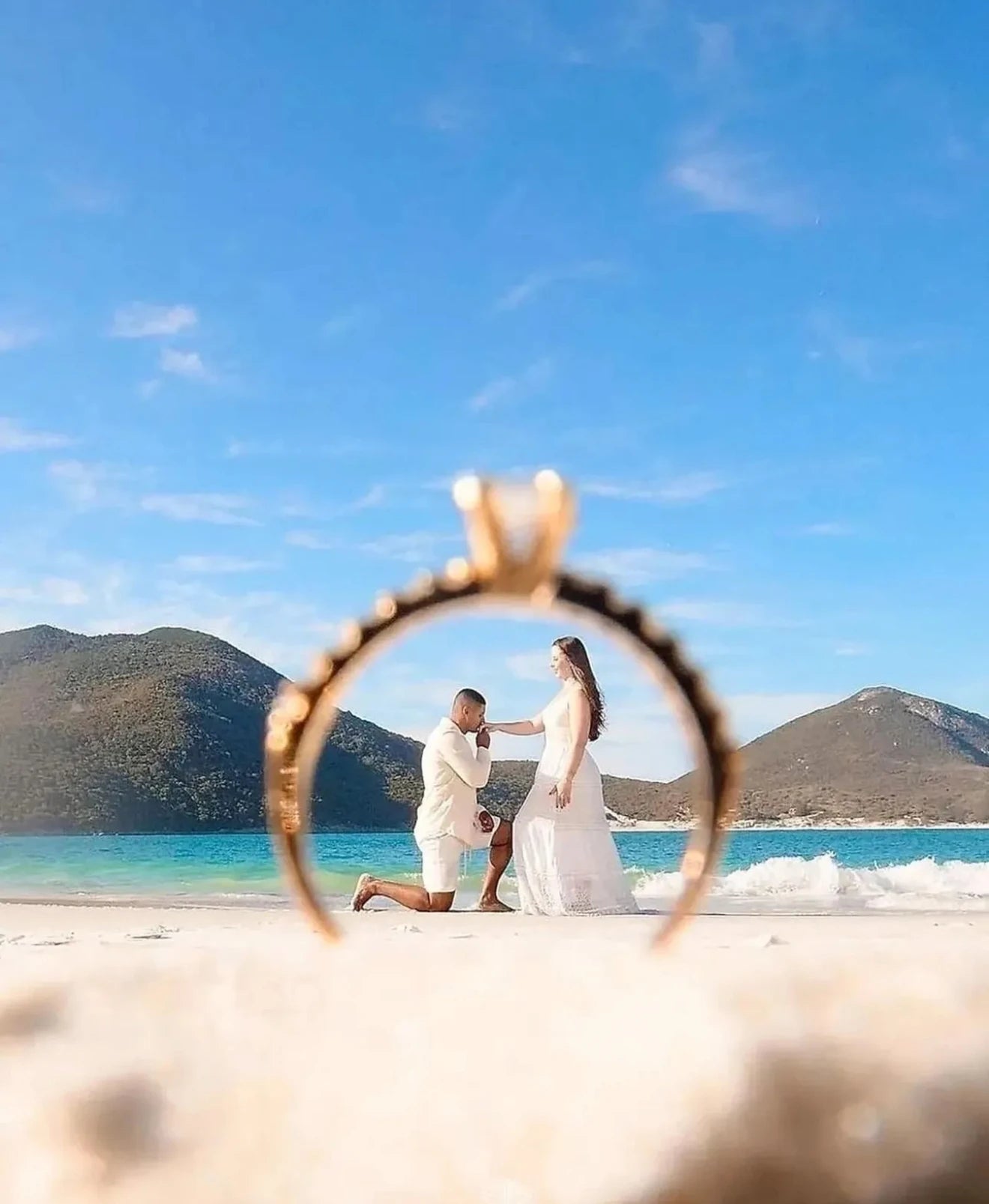 Couple on a beach with a ring