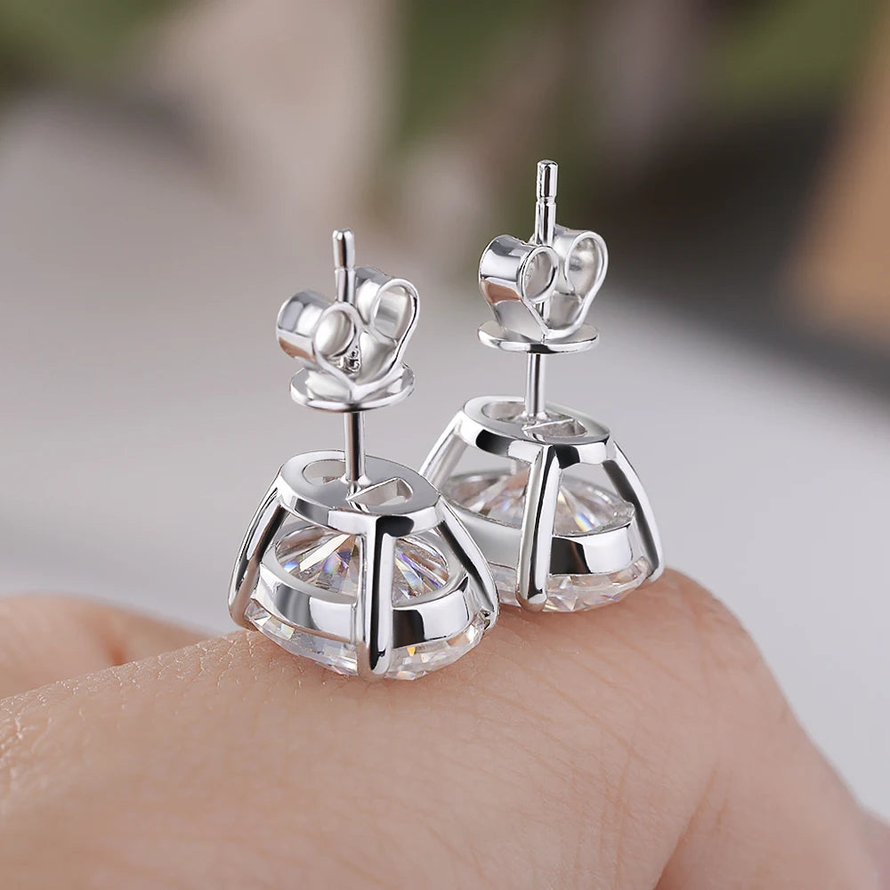 Silver earrings with clear gemstones on a blurred background