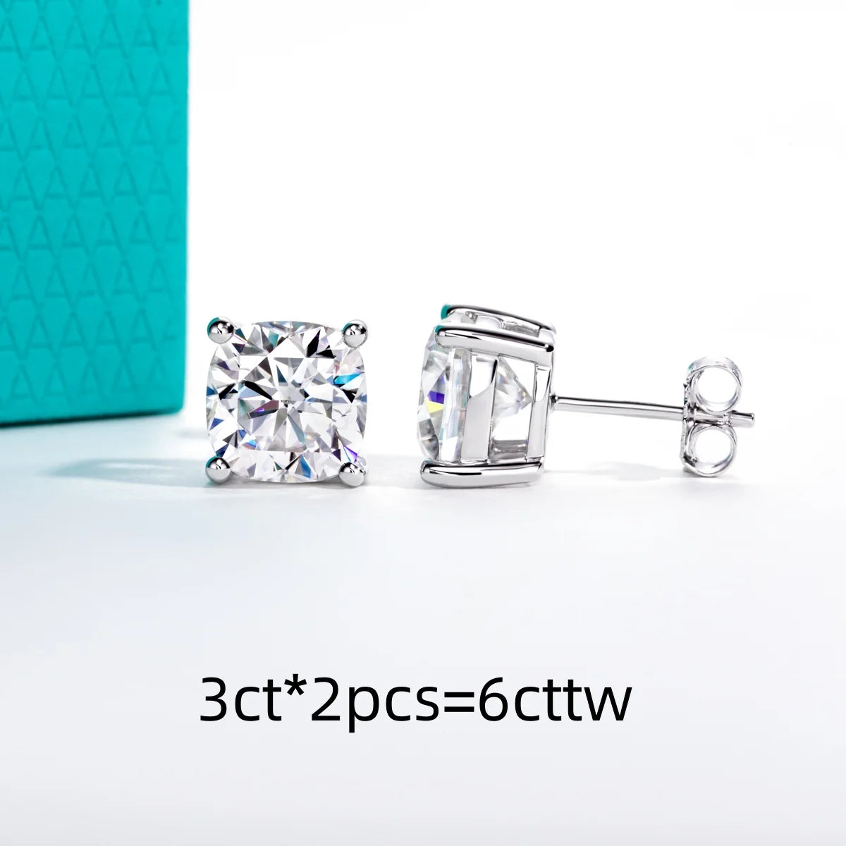 Pair of diamond stud earrings with a turquoise box in the background