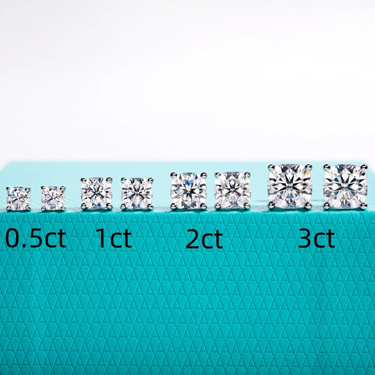 Diamonds of different carat weights on a textured blue background