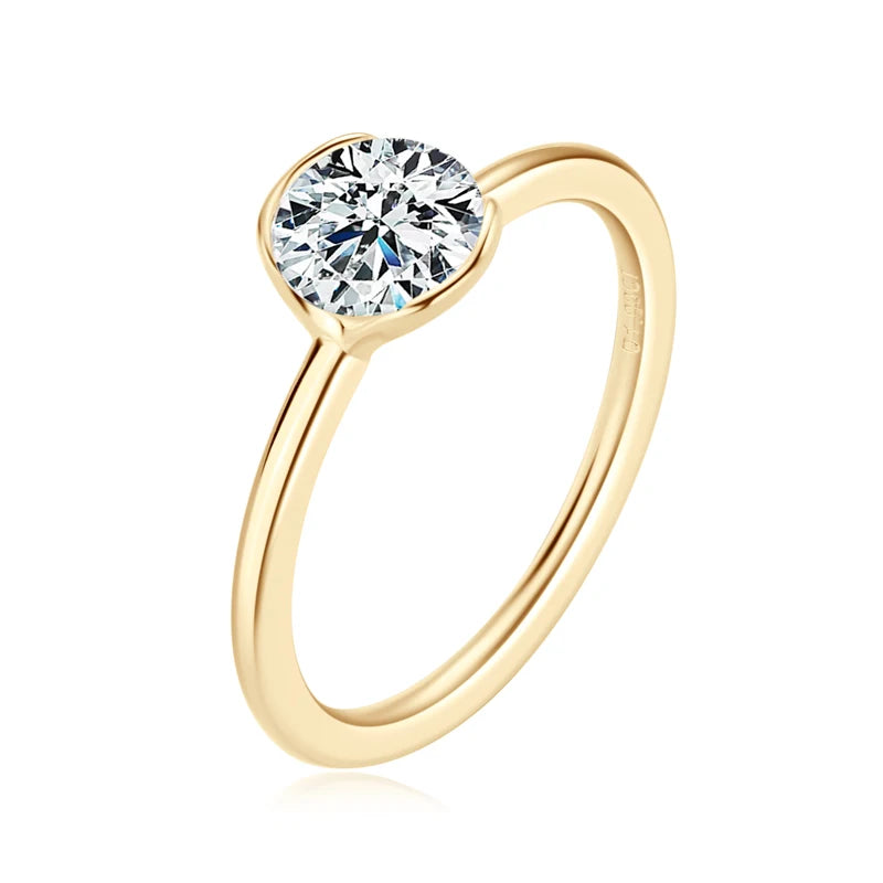 Gold ring with a clear gemstone on a white background