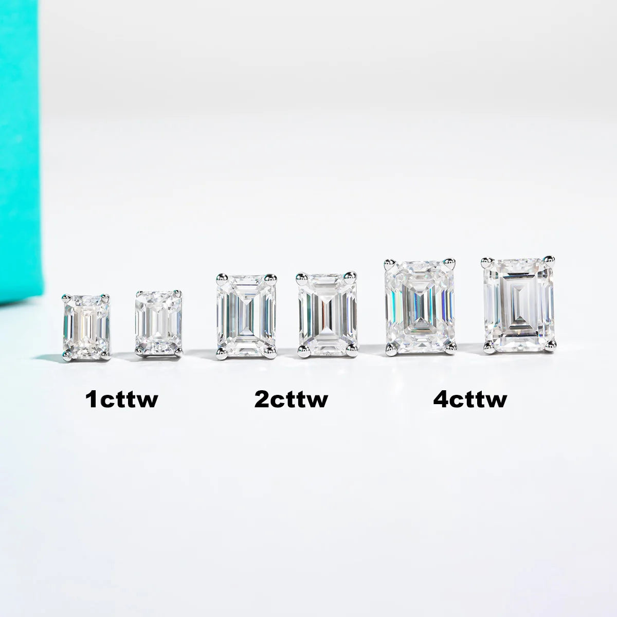 Set of emerald-cut diamonds of different weights on a white background