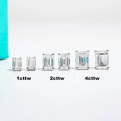 Set of emerald-cut diamonds of different weights on a white background