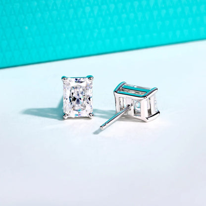 Silver stud earrings with clear gemstones on a light blue background
