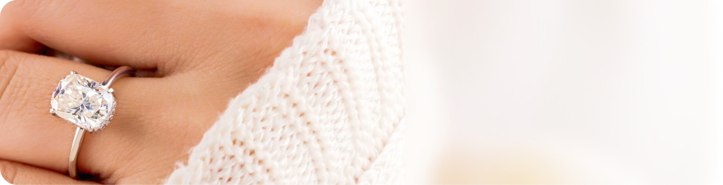 Diamond ring on a hand with a blurred background
